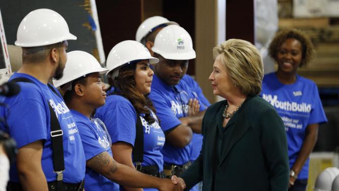 Democratic presidential candidate Hillary Clinton, second from right, meets with students at a Youthbuild program Friday, Feb. 19, 2016, in Las Vegas. Youthbuild helps low-income young people learn construction skills. (AP Photo/John Locher)
