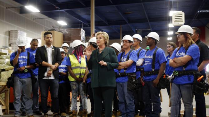 Democratic presidential candidate Hillary Clinton, center, visits a Youthbuild program Friday, Feb. 19, 2016, in Las Vegas. Youthbuild helps low-income young people learn construction skills. (AP Photo/John Locher)