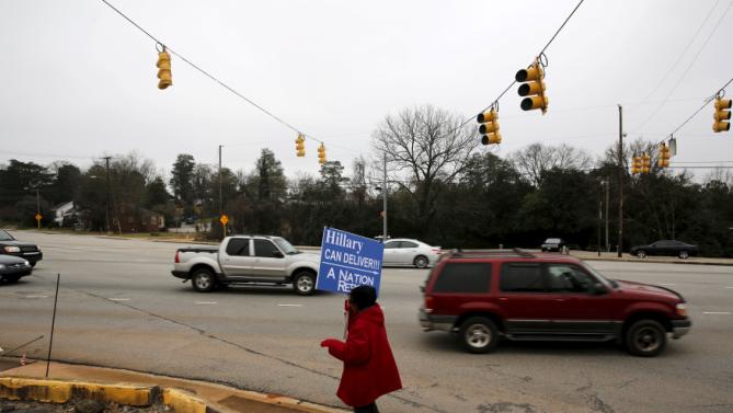 Viola Rocker holds a sign reading "Hillary can deliver" on a sidewalk near where U.S. Democratic presidential candidate Hillary Clinton will hold a town hall meeting at Central Baptist Church in Columbia, South Carolina February 23, 2016. REUTERS/Jonathan Ernst