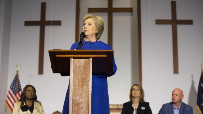 Democratic presidential candidate Hillary Clinton speaks during a rally at the Central Baptist Church in Columbia, S.C., on Tuesday, Feb. 23, 2016, with mothers of victims of gun violence including Sybrina Fulton, mother of Trayvon Martin, left, and former Rep. Gabrielle Giffords with her husband, retired astronaut Mark Kelly. (AP Photo/Jacquelyn Martin)