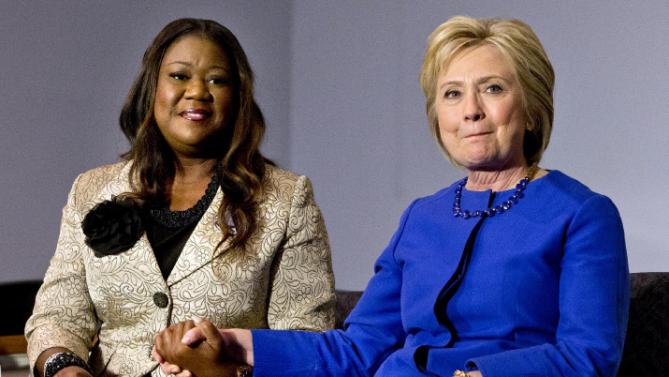 Democratic presidential candidate Hillary Clinton, right, holds hands with Sybrina Fulton, mother of Trayvon Martin, as she reacts to Fulton's statement during a rally at the Central Baptist Church in Columbia, S.C., on Tuesday, Feb. 23, 2016. Clinton spoke and then heard from mothers of victims of gun violence. (AP Photo/Jacquelyn Martin)