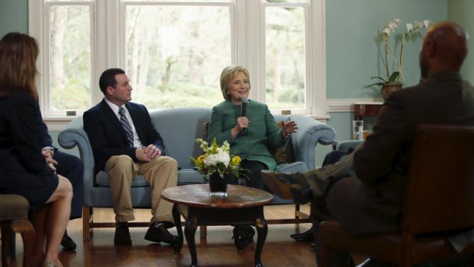U.S. Democratic presidential candidate Hillary Clinton (center R) speaks with Jeff Ballard (center L), facilities director for the SC STRONG, and other residents on a tour of the home for ex-offenders and substance abusers on the grounds of the former Charleston Navy Yard in North Charleston, South Carolina February 24, 2016. REUTERS/Jonathan Ernst