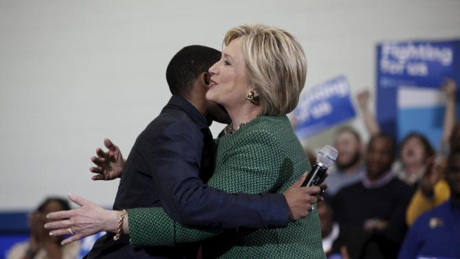 U.S. Democratic presidential candidate Hillary Clinton hugs Morris College Junior class President Jake Sanders III at a town hall at the Garrick-Boykin Human Development Center at Morris College in Sumter, South Carolina, February 24, 2016. REUTERS/Randall Hill