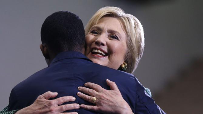 Democratic presidential candidate Hillary Clinton hugs Morris College junior class president Jake Sanders III, as he introduces her to speak at a campaign event at in Sumter, S.C., Wednesday, Feb. 24, 2016. (AP Photo/Gerald Herbert)