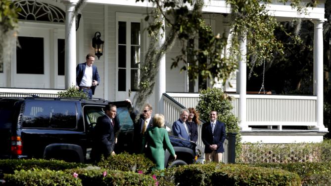 U.S. Democratic presidential candidate Hillary Clinton (C, back to camera in green coat) arrives for a tour of SC STRONG, a home for ex-offenders and substance abusers on the grounds of the former Charleston Navy Yard in North Charleston, South Carolina February 24, 2016. REUTERS/Jonathan Ernst