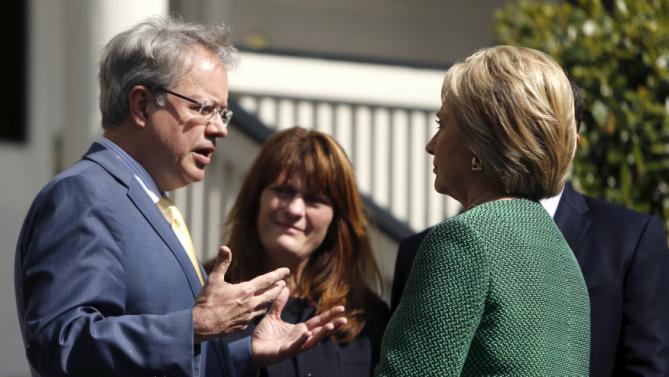 U.S. Democratic presidential candidate Hillary Clinton (R) speaks with Charleston Mayor John Tecklenburg (L) and his wife Sandy (2nd L) as she arrives for a tour of SC STRONG, a home for ex-offenders and substance abusers on the grounds of the former Charleston Navy Yard in North Charleston, South Carolina February 24, 2016. REUTERS/Jonathan Ernst