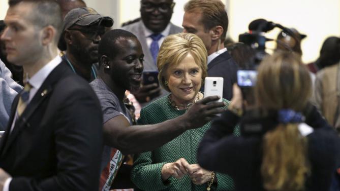 U.S. Democratic presidential candidate Hillary Clinton smiles as she records a Snapchat video for a supporter at the International Longshoremen's Association Local 1422 in Charleston, South Carolina February 24, 2016. REUTERS/Jonathan Ernst