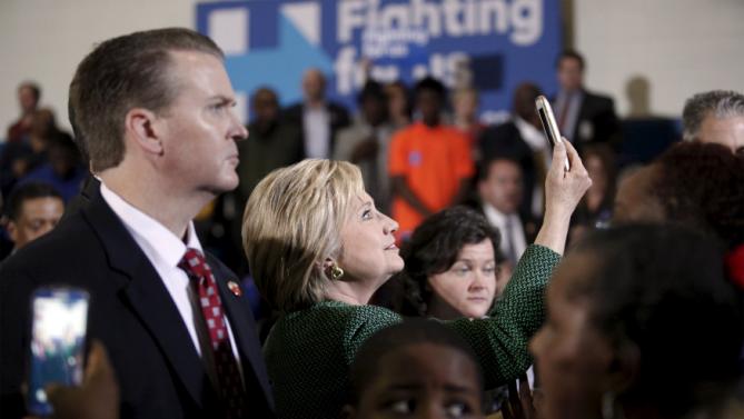U.S. Democratic presidential candidate Hillary Clinton (C) takes a selfie for a supporter after her speech at the Garrick-Boykin Human Development Center at Morris College in Sumter, South Carolina, February 24, 2016. REUTERS/Randall Hill