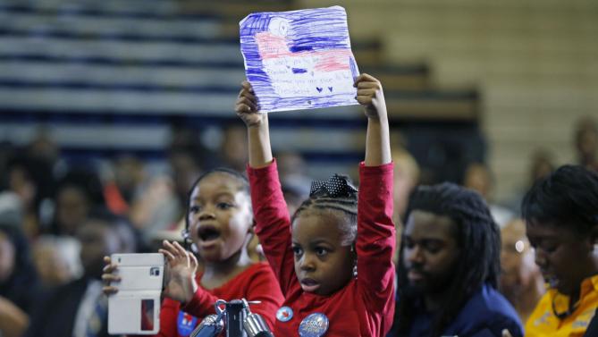 Kaylen Johnson, left, and London Walters, both 6, hold a drawing and take pictures before Democratic presidential candidate Hillary Clinton walks onstage to speak at a campaign event at Morris College in Sumter, S.C., Wednesday, Feb. 24, 2016. (AP Photo/Gerald Herbert)