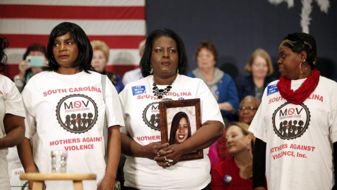 Barbara Hytower (C), holding a photo of her daughter Jamila, stands with other members of the South Carolina Mothers Against Violence before the start of a rally for U.S. Democratic presidential candidate Hillary Clinton at the Myrtle Beach Convention Center in Myrtle Beach, South Carolina, February 25, 2016. Jamila Hytower was murdered in 2006 in Myrtle Beach. REUTERS/Randall Hill
