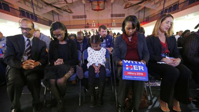 Audience members bow their heads in prayer during the invocation before Democratic presidential candidate Hillary Clinton arrives tospeak at a campaign event at the Royal Baptist Church Family Life Center in North Charleston, S.C., Thursday, Feb. 25, 2016. (AP Photo/Gerald Herbert)