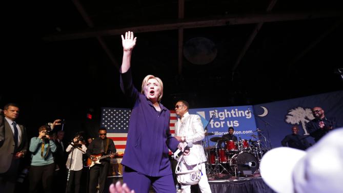 Democratic presidential candidate Hillary Clinton appears onstage with recording artist Charlie Wilson during a "Get Out The Vote" concert at The Music Farm in Charleston, S.C., Thursday, Feb. 25, 2016. (AP Photo/Gerald Herbert)