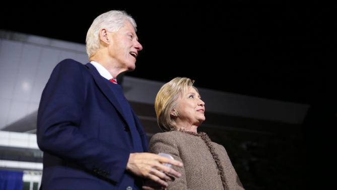 Democratic presidential candidate Hillary Clinton and her husband, former President Bill Clinton, arrive onstage to speak at a "Get Out The Vote Rally" in Columbia, S.C., Friday, Feb. 26, 2016. (AP Photo/Gerald Herbert)