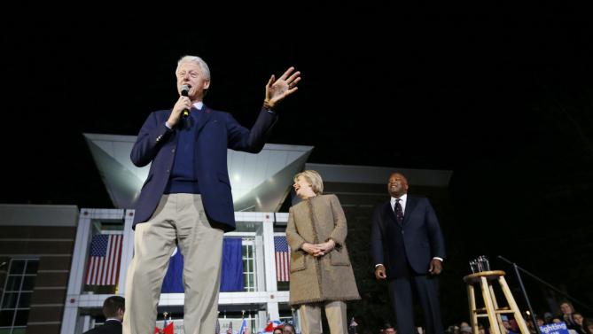 Democratic presidential candidate Hillary Clinton and her husband, former President Bill Clinton, speak at a "Get Out The Vote Rally" in Columbia, S.C., Friday, Feb. 26, 2016. Right is Columbia Mayor Stephen K. Benjamin. (AP Photo/Gerald Herbert)
