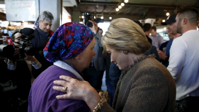 U.S. Democratic Presidential candidate Hillary Clinton listens to a worker at Saffron Cafe and Bakery as she arrives to greet voters at the cafe in Charleston, South Carolina, February 26, 2016. REUTERS/Jonathan Ernst