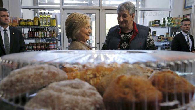 U.S. Democratic presidential candidate Hillary Clinton speaks with Saffron Cafe and Bakery owner Ali Rahnamoon as she arrives to greet people at his cafe in Charleston, South Carolina February 26, 2016. REUTERS/Jonathan Ernst