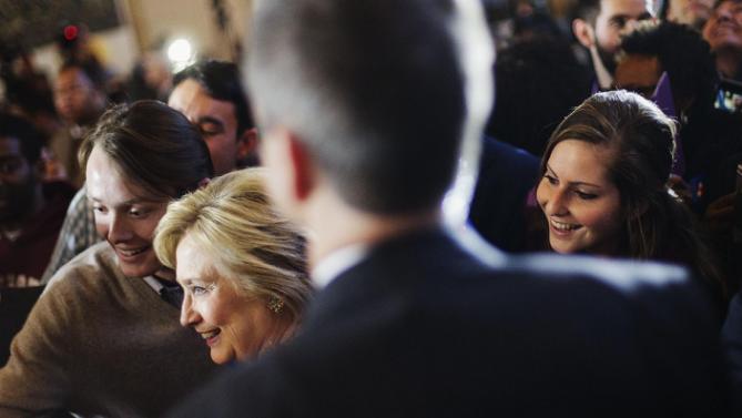 An audience member at right photo bombs a selfie with Democratic presidential candidate Hillary Clinton as she greets the crowd at a campaign event at the Old City Council Chambers in City Hall, Friday, Feb. 26, 2016, in Atlanta. (AP Photo/David Goldman)