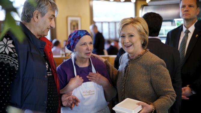 U.S. Democratic presidential candidate Hillary Clinton greets Saffron Cafe and Bakery diners and workers, including owner Ali Rahnamoon, in Charleston, South Carolina February 26, 2016. REUTERS/Jonathan Ernst