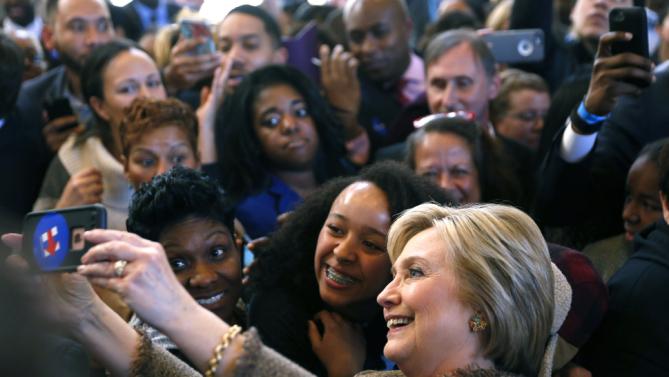 RE-FILING CLARIFYING LOCATION OF PHOTO Democratic U.S. presidential candidate Hillary Clinton takes selfies with people during a campaign stop at Atlanta City Hall in Atlanta, Georgia February 26, 2016. REUTERS/Christopher Aluka Berry