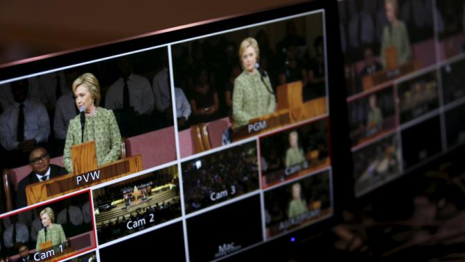 U.S. Democratic presidential candidate Hillary Clinton appears on the television monitors as she speaks during a worship service at the Mississippi Boulevard Christian Church in Memphis, Tennessee, February 28, 2016. REUTERS/Jonathan Ernst