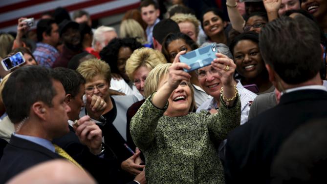U.S. Democratic presidential candidate Hillary Clinton takes a selfie with supporters at Meharry Medical College in Nashville, Tennessee, February 28, 2016. REUTERS/Jonathan Ernst