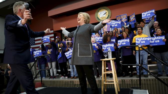 U.S. Democratic presidential candidate Hillary Clinton (C) takes the stage with Virginia Governor Terry McAuliffe to rally with supporters at George Mason University in Fairfax, Virginia February 29, 2016. REUTERS/Jonathan Ernst
