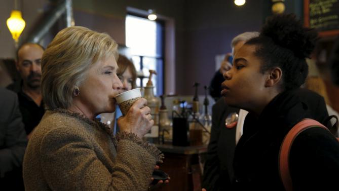 U.S. Democratic presidential candidate Hillary Clinton has an exchange with a young woman asking questions about issues pertaining to the Somali-American community as she greets people at Mapps Coffee in Minneapolis, Minnesota March 1, 2016. REUTERS/Jonathan Ernst