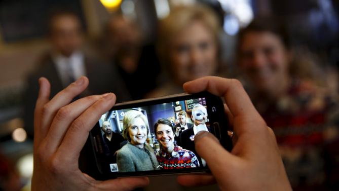 U.S. Democratic presidential candidate Hillary Clinton poses for a picture while meeting people at Mapps Coffee in Minneapolis, Minnesota March 1, 2016. REUTERS/Jonathan Ernst