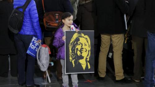 A supporter holds a sign with the likeness of U.S. presidential candidate and former Secretary of State Hillary Clinton before a rally as she campaigns for the 2016 Democratic presidential nomination in New York March 2, 2016. REUTERS/Lucas Jackson