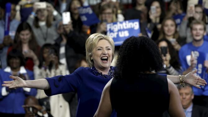U.S. Democratic presidential candidate Hillary Clinton greets Alethea Williams as she takes the stage to speak to supporters at a campaign event in the Manhattan borough of New York City, March 2, 2016. REUTERS/Mike Segar