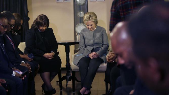 Democratic presidential candidate Hillary Clinton prays with African American ministers, Saturday, March 5, 2016, in Detroit. (AP Photo/Carlos Osorio)
