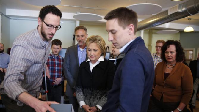 U.S. Democratic presidential candidate Hillary Clinton talks to employees as she visits Atomic Object company during a campaign stop in Grand Rapids, Michigan, March 7, 2016. REUTERS/Carlos Barria