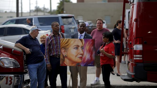 A supporter of Democratic U.S. presidential candidate Hillary Clinton holds a painting of her outside a campaign rally site in Tampa, Florida, March 10, 2016. REUTERS/Carlos Barria EDITORIAL USE ONLY. NO RESALES. NO ARCHIVE