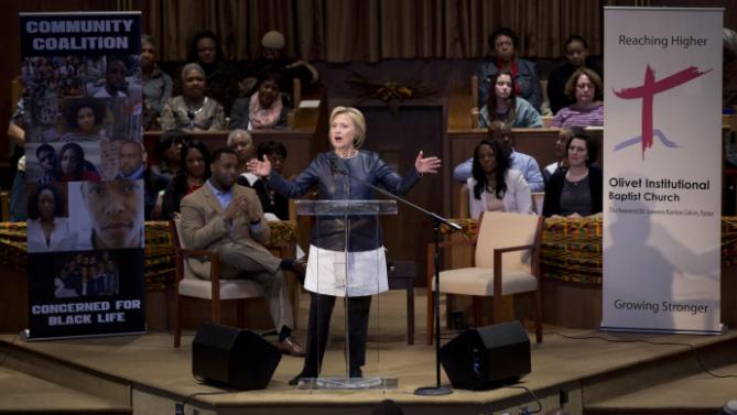 Democratic presidential candidate Hillary Clinton speaks during a town hall meeting at Olivet Institutional Baptist Church in Cleveland, Saturday, March 12, 2016. Seated at left is Rev. Dr. Jawanza Karriem Colvin. (AP Photo/Carolyn Kaster)