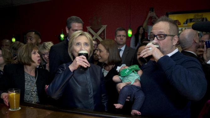 Democratic presidential candidate Hillary Clinton has a Guinness at the packed O'Donold's Irish Pub and Grill in Youngstown, Ohio, Saturday, March 12, 2016. (AP Photo/Carolyn Kaster)