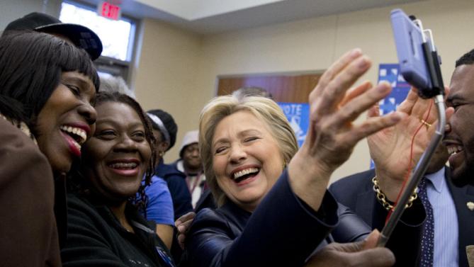 Democratic presidential candidate Hillary Clinton lags as she poses for photos with supporters after speaking at the the O'Fallon Park Recreation Complex in St. Louis, Saturday, March 12, 2016. (AP Photo/Carolyn Kaster)