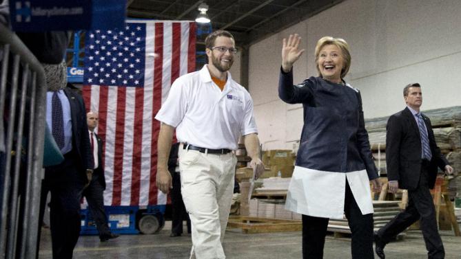 Democratic presidential candidate Hillary Clinton walks with student Nathan Garrett as they arrive at a campaign event at the Nelson-Mulligan Carpenters’ Training Center in St. Louis, Saturday, March 12, 2016. (AP Photo/Carolyn Kaster)