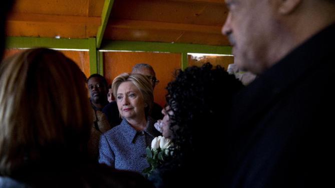 Democratic presidential candidate Hillary Clinton, joined by Rev. Jesse Jackson, right, and Diane Latiker of Kids off the Block memorial, second from right, visits the memorial to children killed by gun violence in Chicago, Monday, March 14, 2016. (AP Photo/Carolyn Kaster)