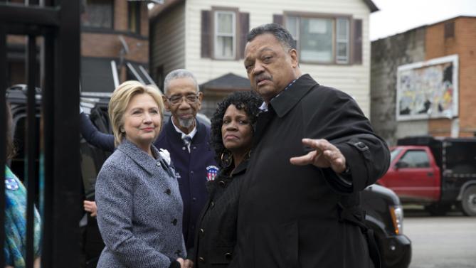 Democratic presidential candidate Hillary Clinton, is greeted by Rev. Jesse Jackson, right, Diane Latiker of Kids off the Block memorial, second from right, and Rep Bobby Rush, D-Ill., as she arrives to visit Kids off the Block memorial l to children killed by gun violence in Chicago, Monday, March 14, 2016. (AP Photo/Carolyn Kaster)