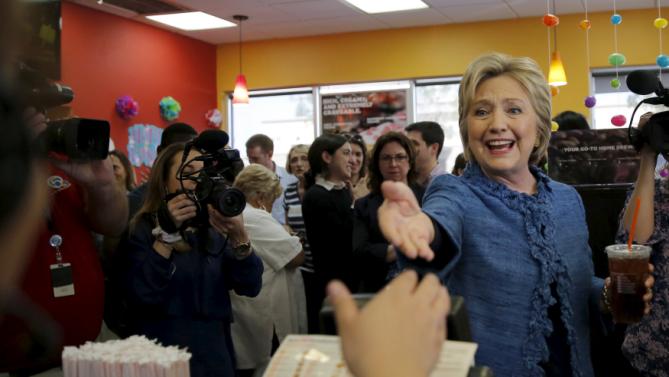 Democratic U.S. Presidential candidate Hillary Clinton shakes hands with employees at a Dunkin' Donuts coffee shop during a campaign stop in West Palm Beach, Florida March 15, 2016. REUTERS/Carlos Barria