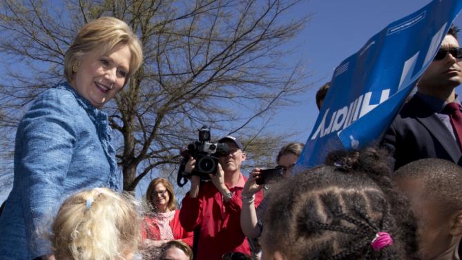 Democratic presidential candidate Hillary Clinton talks with a group of little kids as she visits a polling place a Southeast Raleigh Magnet High School in Raleigh, N.C., Tuesday, March 15, 2016. (AP Photo/Carolyn Kaster)