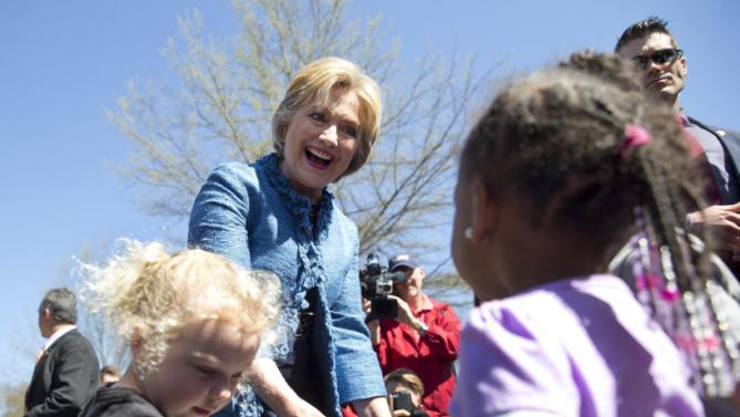 Democratic presidential candidate Hillary Clinton visits talks with a group of little kids as she visits a polling place a Southeast Raleigh Magnet High School in Raleigh, N.C., Tuesday, March 15, 2016. (AP Photo/Carolyn Kaster)