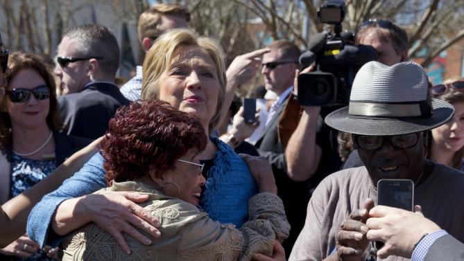 Democratic presidential candidate Hillary Clinton hugs a supporter as she visits a polling place a Southeast Raleigh Magnet High School in Raleigh, N.C., Tuesday, March 15, 2016. (AP Photo/Carolyn Kaster)