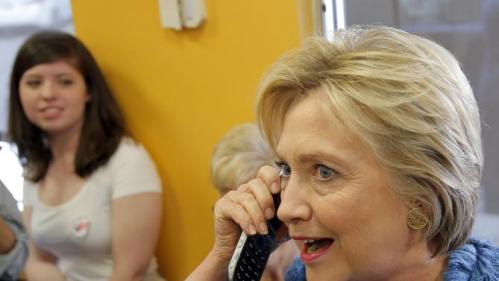 Democratic U.S. Presidential candidate Hillary Clinton talks on the phone at a Dunkin' Donuts coffee shop during a campaign stop in West Palm Beach, Florida March 15, 2016. REUTERS/Carlos Barria