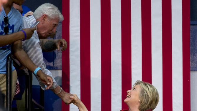 Democratic presidential candidate Hillary Clinton reaches to shake hands as she arrives to speak during a campaign event at Carl Hayden Community High School in Phoenix, Monday, March 21, 2016. (AP Photo/Carolyn Kaster)