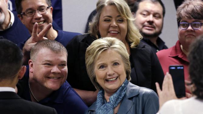 Democratic presidential candidate Hillary Clinton poses for a photo with a group during a campaign event at the Boeing Machinists' union hall Tuesday, March 22, 2016, in Everett, Wash. (AP Photo/Elaine Thompson)