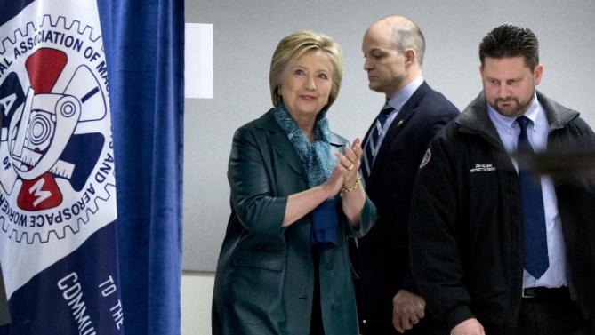 Democratic presidential candidate Hillary Clinton arrives with Union District President Jon Holden, right, for a campaign event at the IAM District 751 Everett Union Hall in Everett, Wash., Tuesday, March 22, 2016. (AP Photo/Carolyn Kaster)