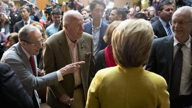 Former Defense Secretary William Perry, left , introduces Democratic presidential candidate Hillary Clinton to his son David Perry, right, as former Secretary of State George Shultz stands second from left, after Clinton spoke about counterterrorism, Wednesday, March 23, 2016, at the Bechtel Conference Center at Stanford University in Stanford, Calif. (AP Photo/Carolyn Kaster)