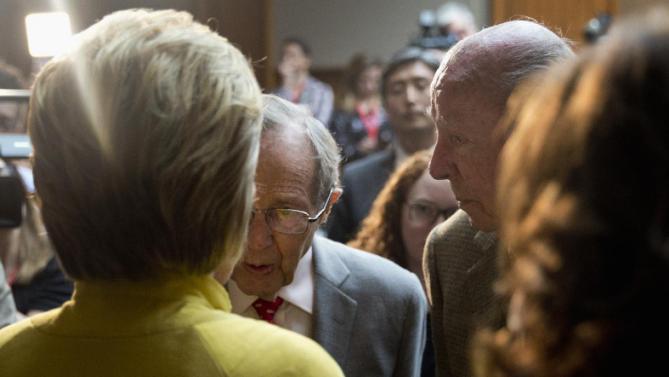 Democratic presidential candidate Hillary Clinton speaks with former Secretary of State George Shultz, right, and former Defense Secretary William Perry, center, after speaking about counterterrorism, Wednesday, March 23, 2016, at the Bechtel Conference Center at Stanford University in Stanford, Calif. (AP Photo/Carolyn Kaster)