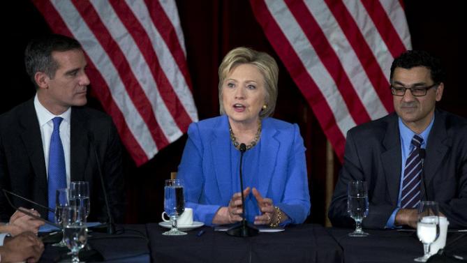 Democratic presidential candidate Hillary Clinton, joined by Los Angeles Mayor Eric Garcetti, left, and President of the Muslim Public Affairs Council Salam Al-Marayati, right, speaks during a roundtable with Muslim community leaders at the University of Southern California in Los Angeles, Thursday, March 24, 2016. (AP Photo/Carolyn Kaster)